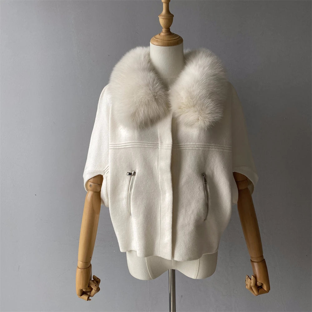 White fur coat on a mannequin against a gray background