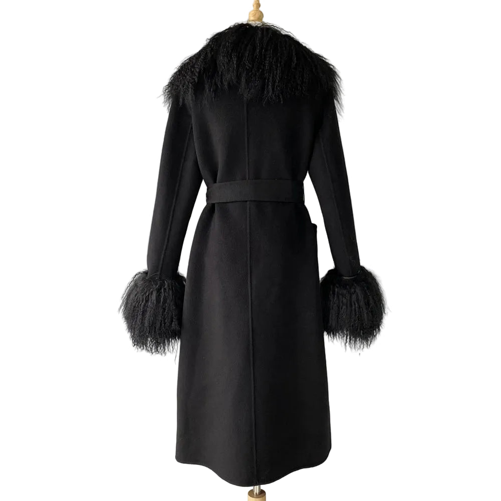 Black coat with feathered cuffs and collar on a mannequin against a plain background