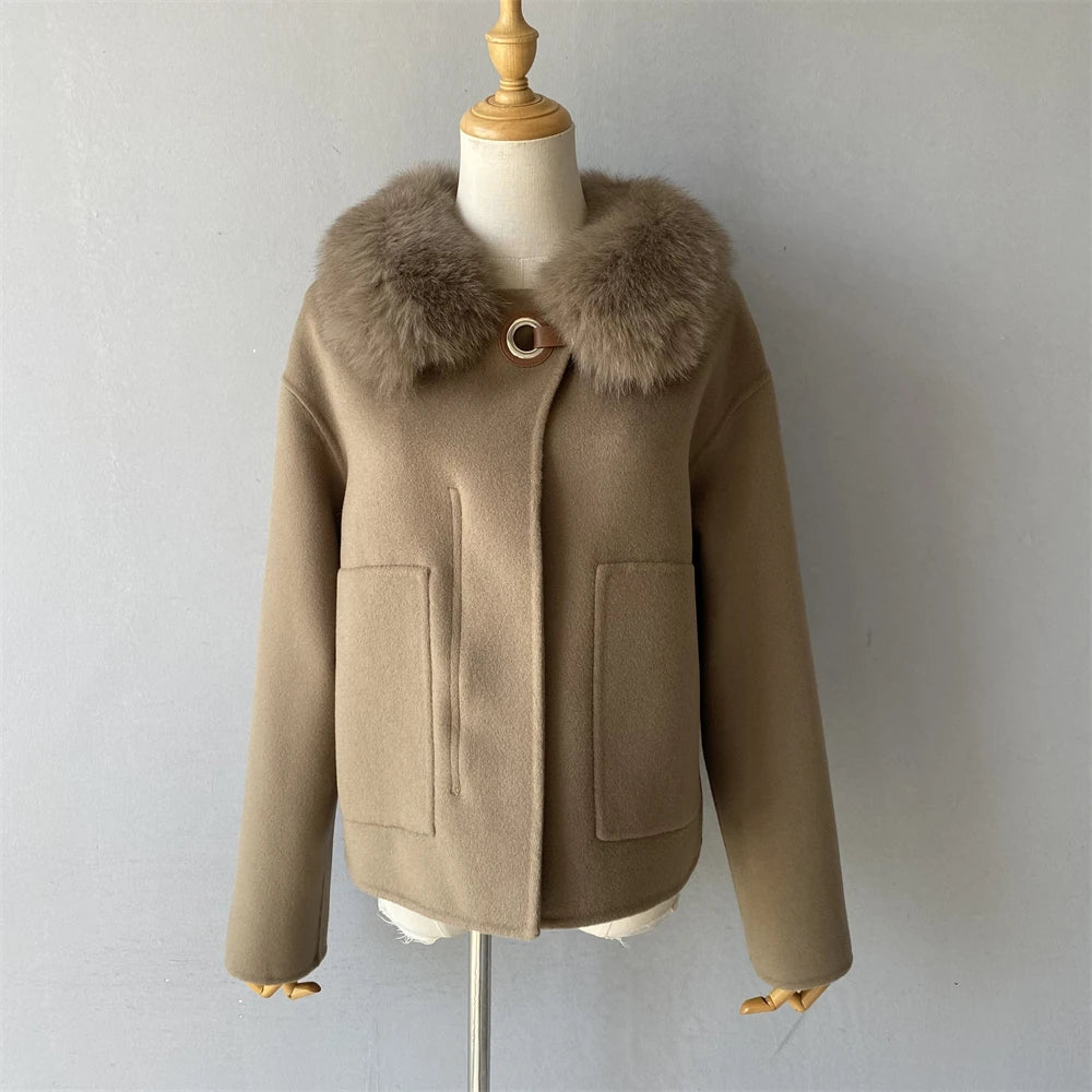 Beige coat with fur collar on a mannequin against a plain background