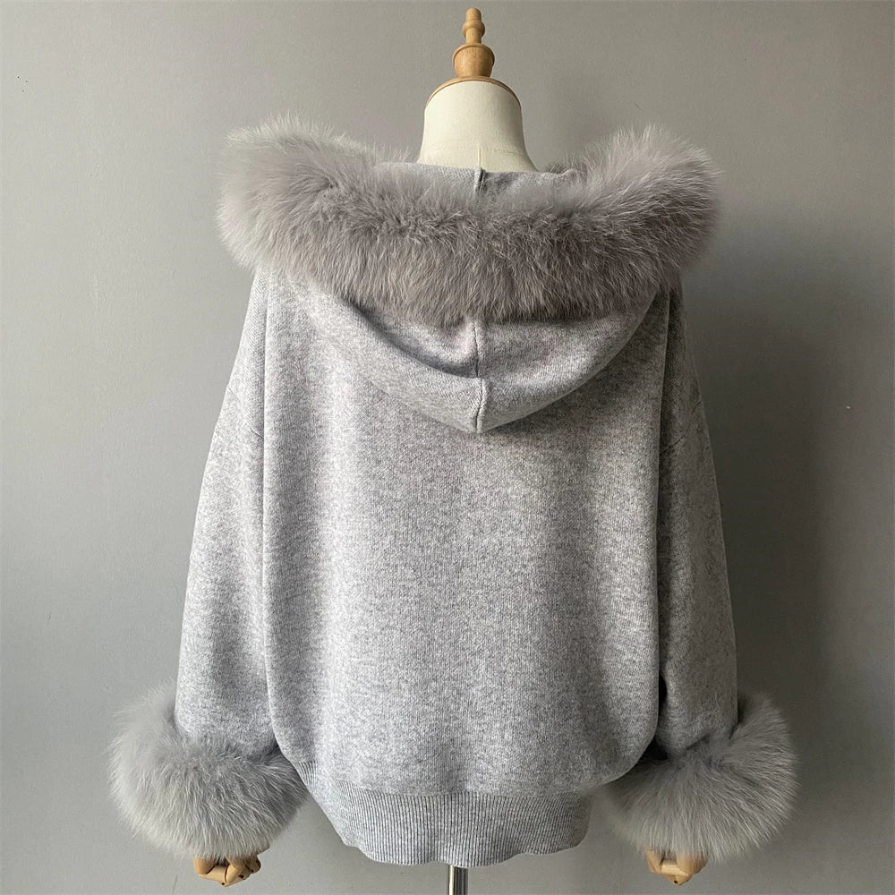Gray hoodie with fur trim on a mannequin against a plain background