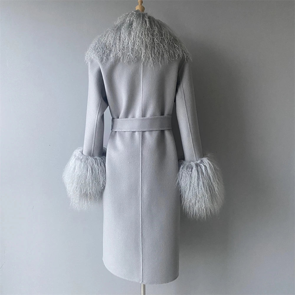 Gray coat with feathered cuffs and collar on a mannequin against a plain background