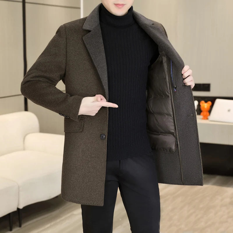 Person wearing a brown coat with a black interior, standing in an indoor setting.