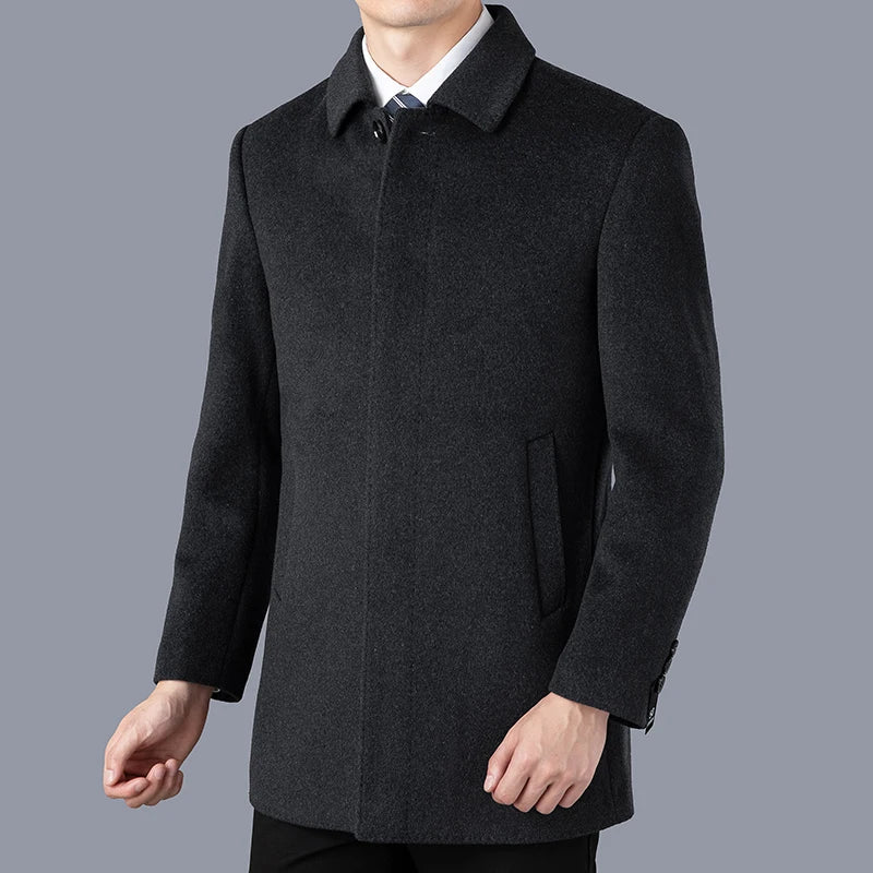 Dark gray coat worn by a person on a gray background