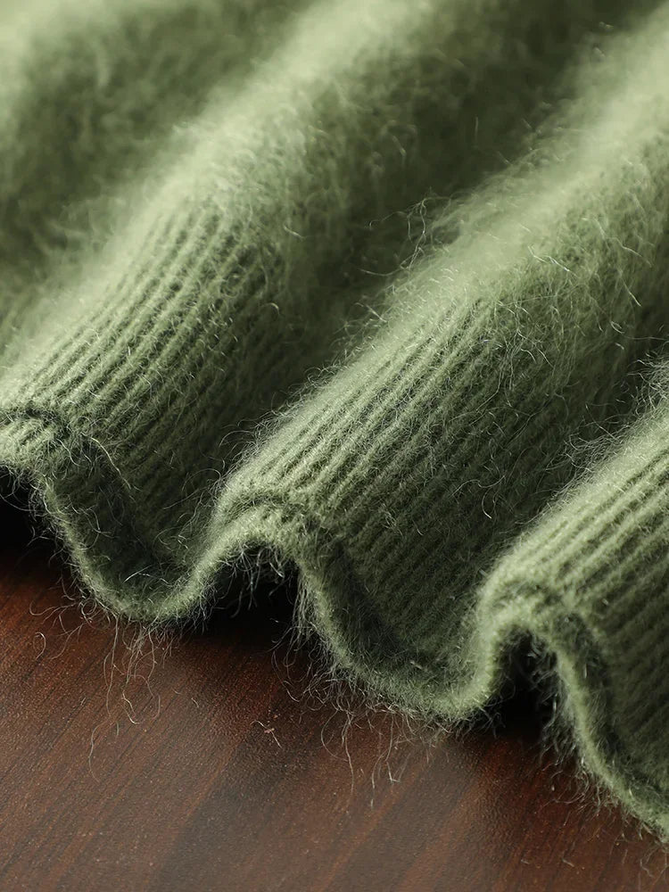 Close-up of a green knitted fabric on a wooden surface