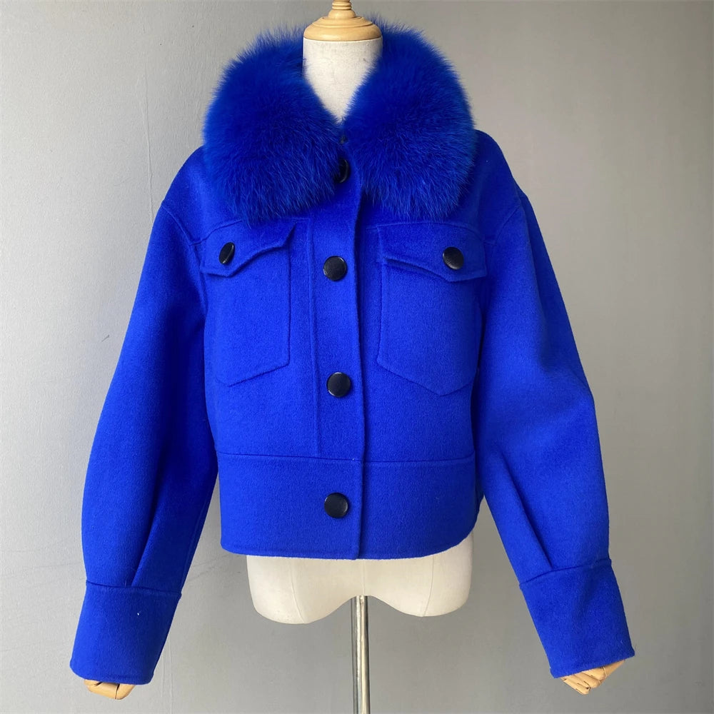 Blue jacket with fur collar on a mannequin against a gray background