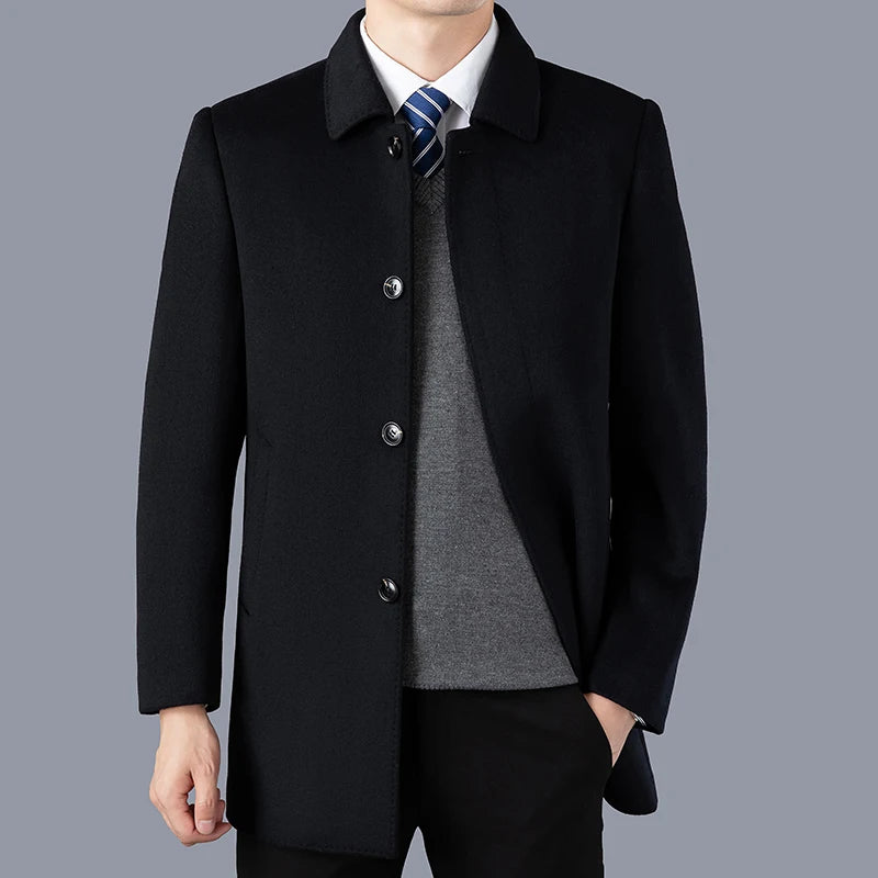 Black coat worn by a person on a gray background
