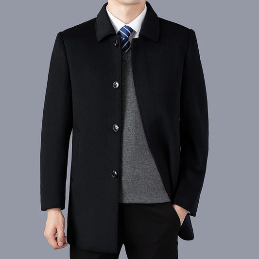 Black coat worn by a person on a gray background