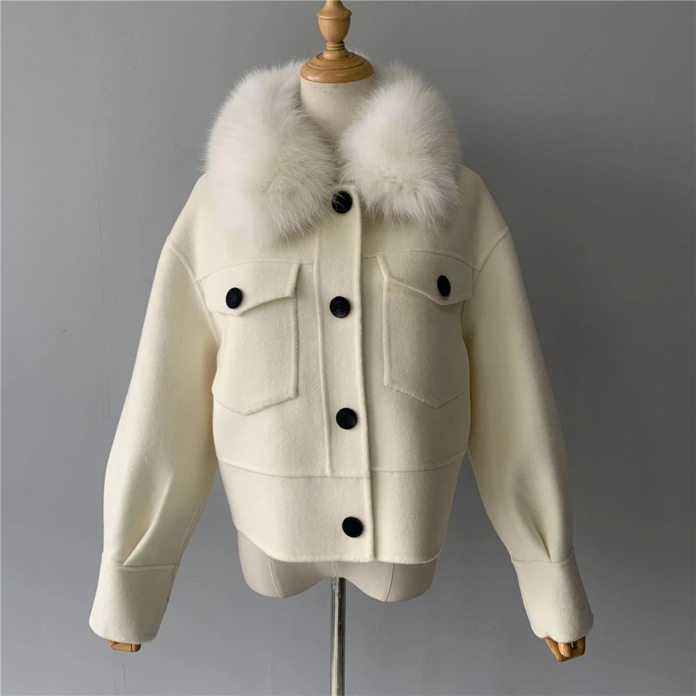 White jacket with fur collar on a mannequin against a gray background