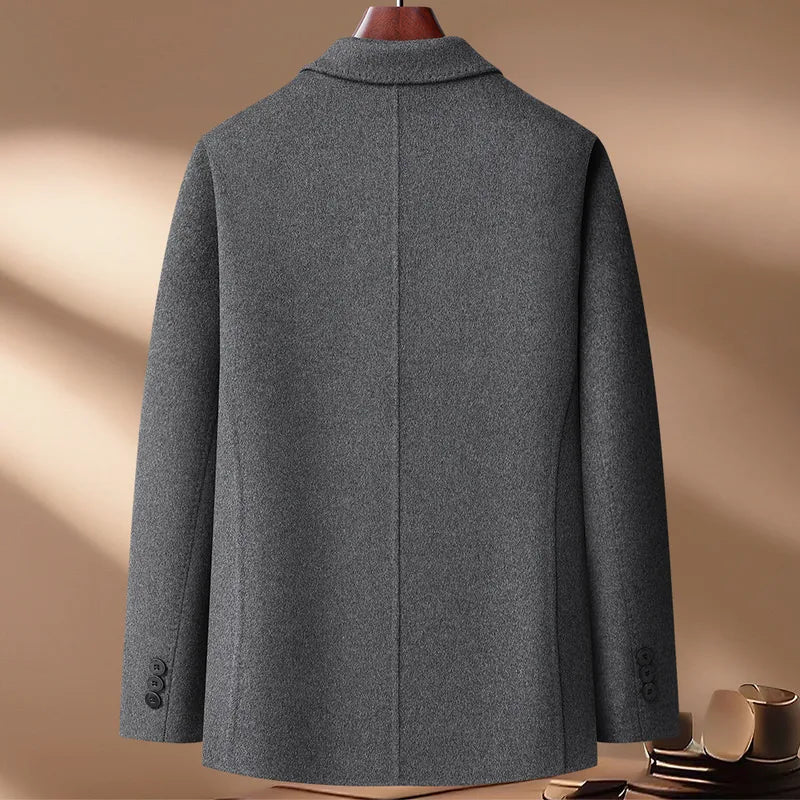 Gray coat on a mannequin against a beige background