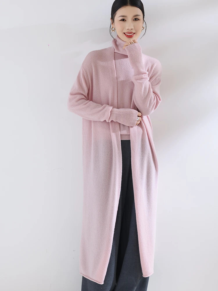 Person wearing a long pink coat against a white background