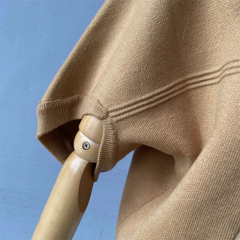 Close-up of a beige sweater on a mannequin against a blue sky background