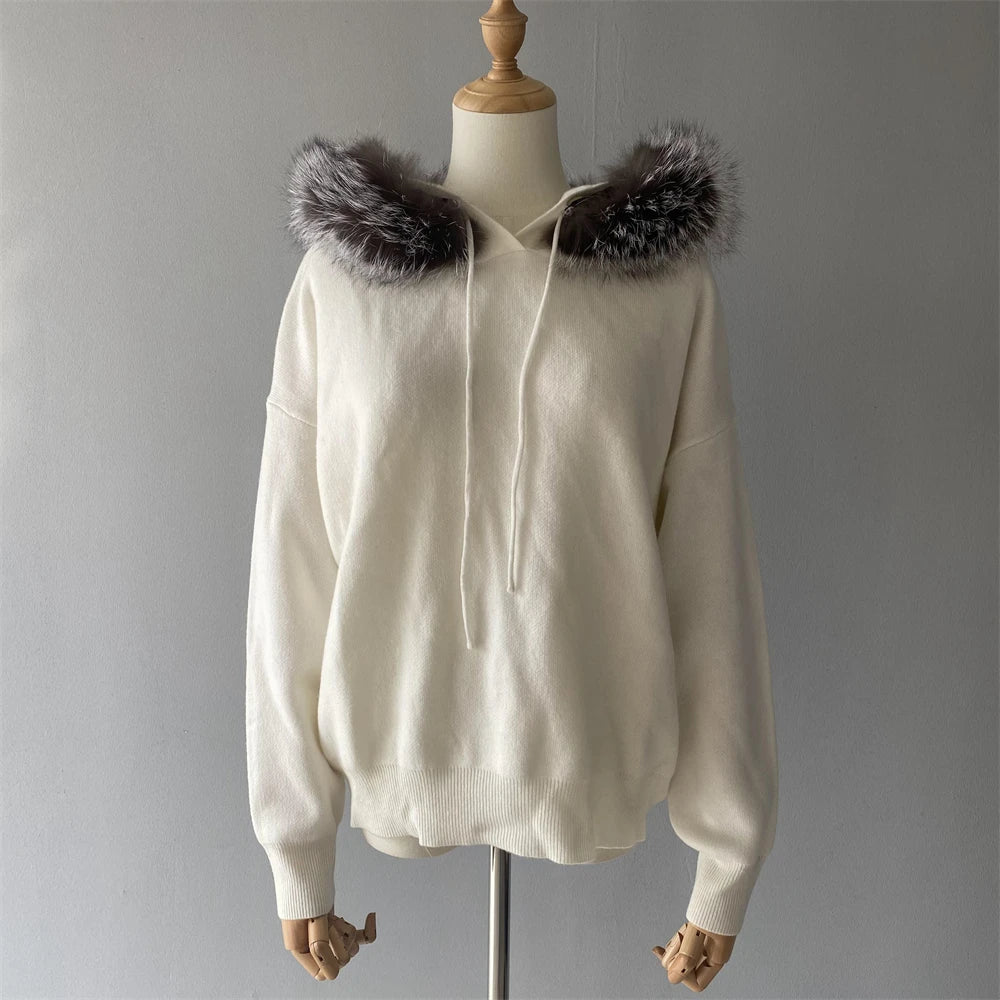 White hoodie with fur hood on a mannequin against a gray background