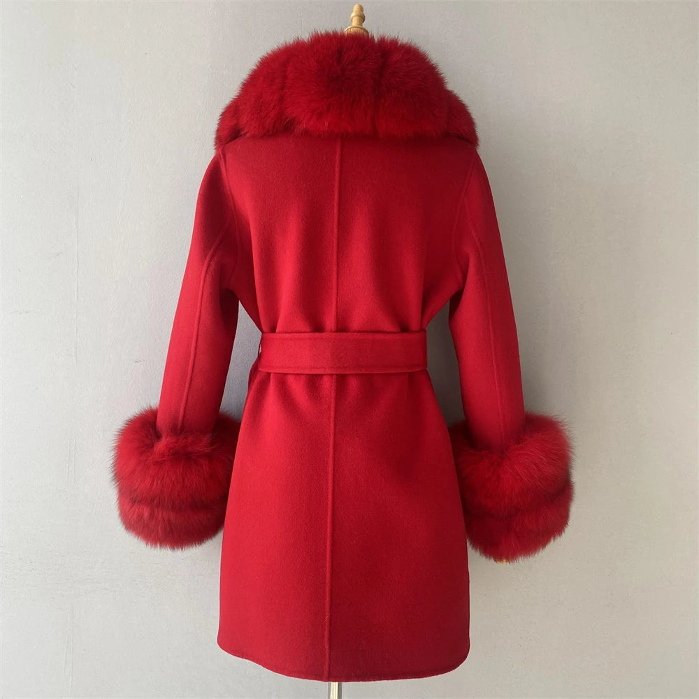 Red coat with fur trim on a mannequin against a plain background