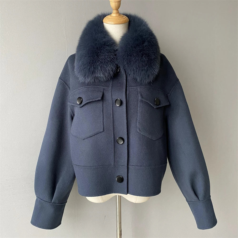 Navy blue jacket with fur collar on a mannequin against a plain background