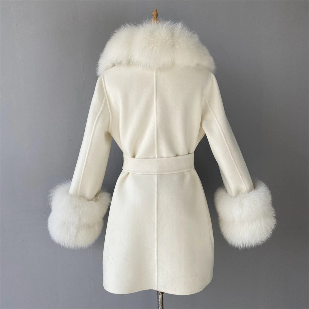 White coat with fur trim on a mannequin against a gray background