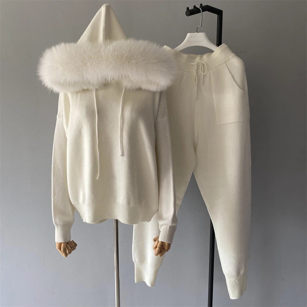 White hoodie with fur-lined hood and matching pants on a gray background