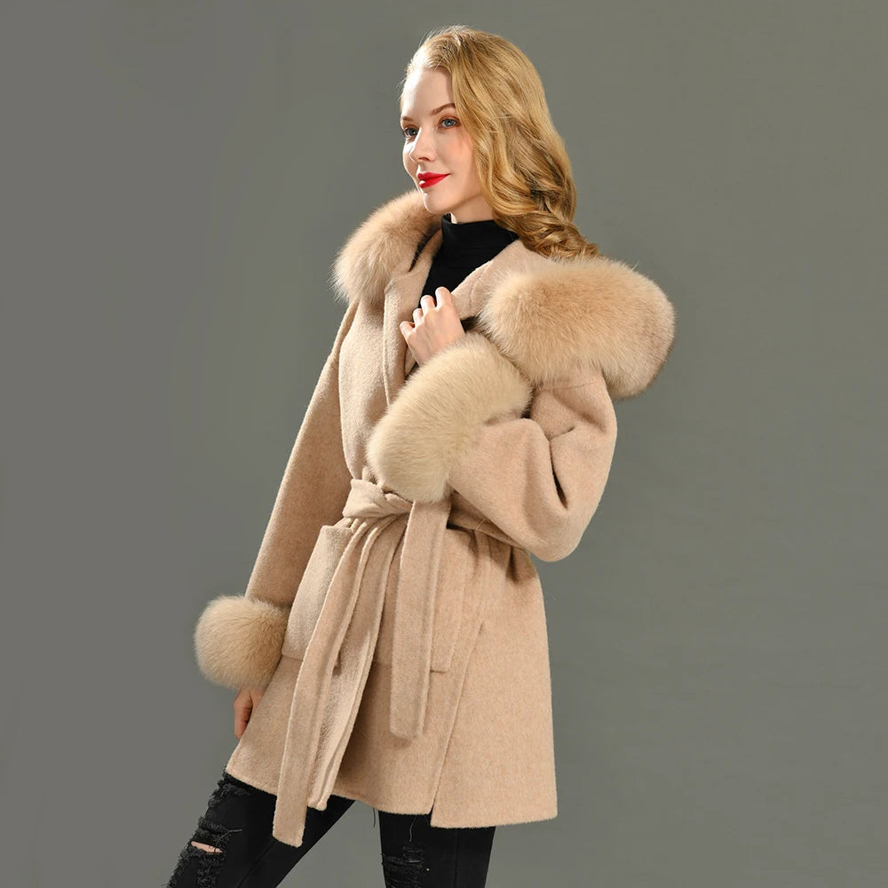Woman wearing a beige coat with fur trim on a gray background