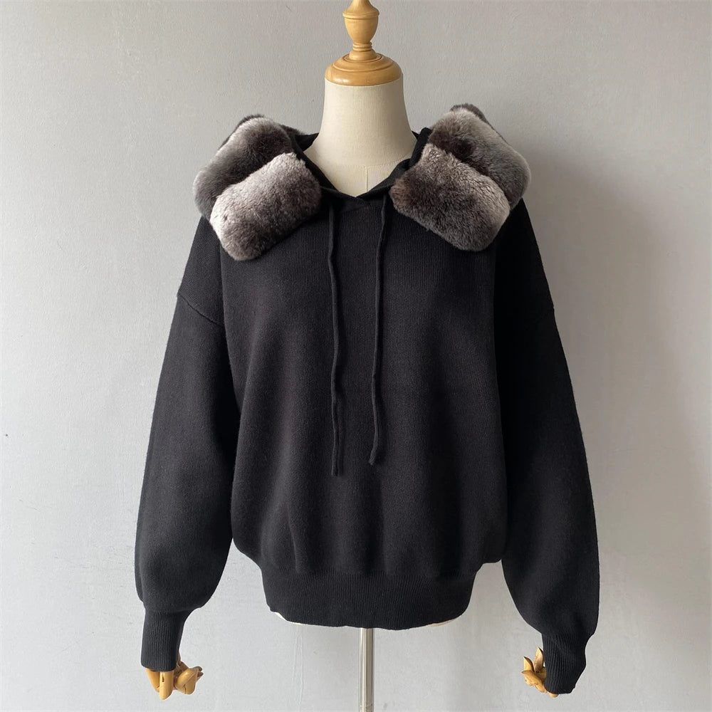 Black hoodie with fur-lined hood on a mannequin against a plain background
