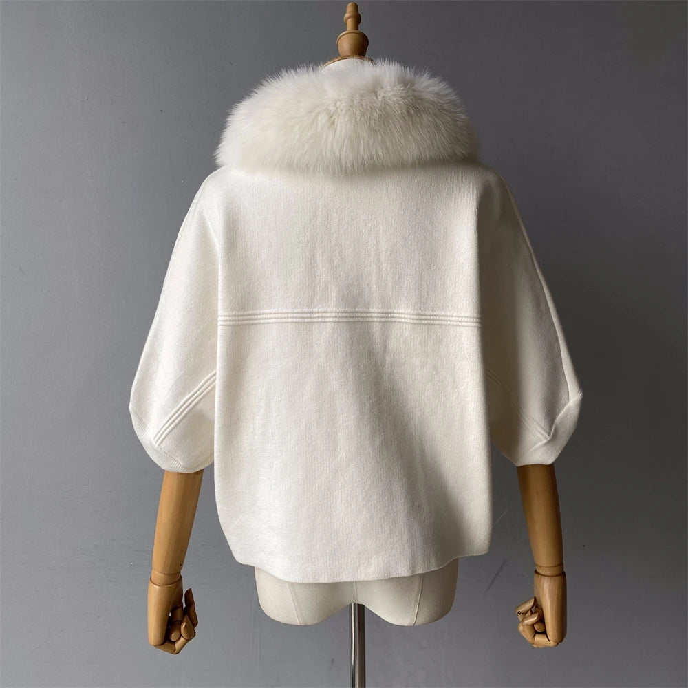 White coat with fur collar on a mannequin against a gray background
