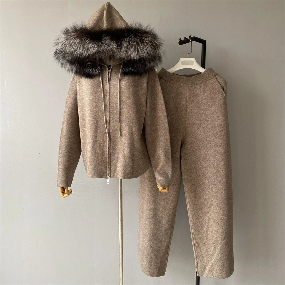 Beige hooded jacket and pants set with fur-lined hood on a hanger against a neutral background.