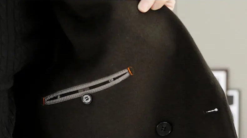Close-up of a black coat with a zipper detail, blurred background