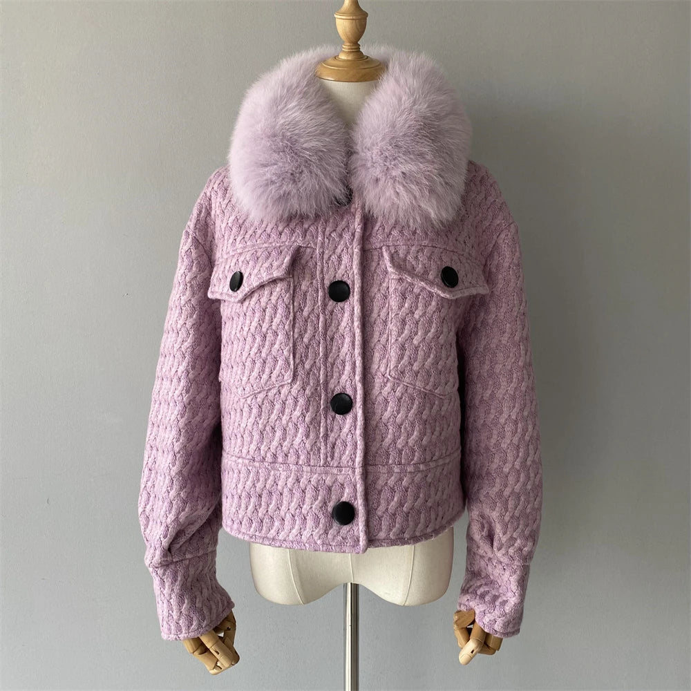 Pink quilted jacket with fur collar on a mannequin against a plain background