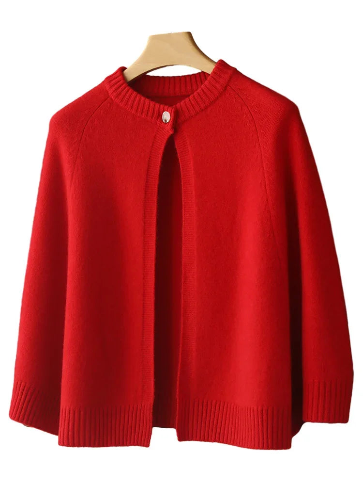 Red sweater on a wooden hanger against a white background