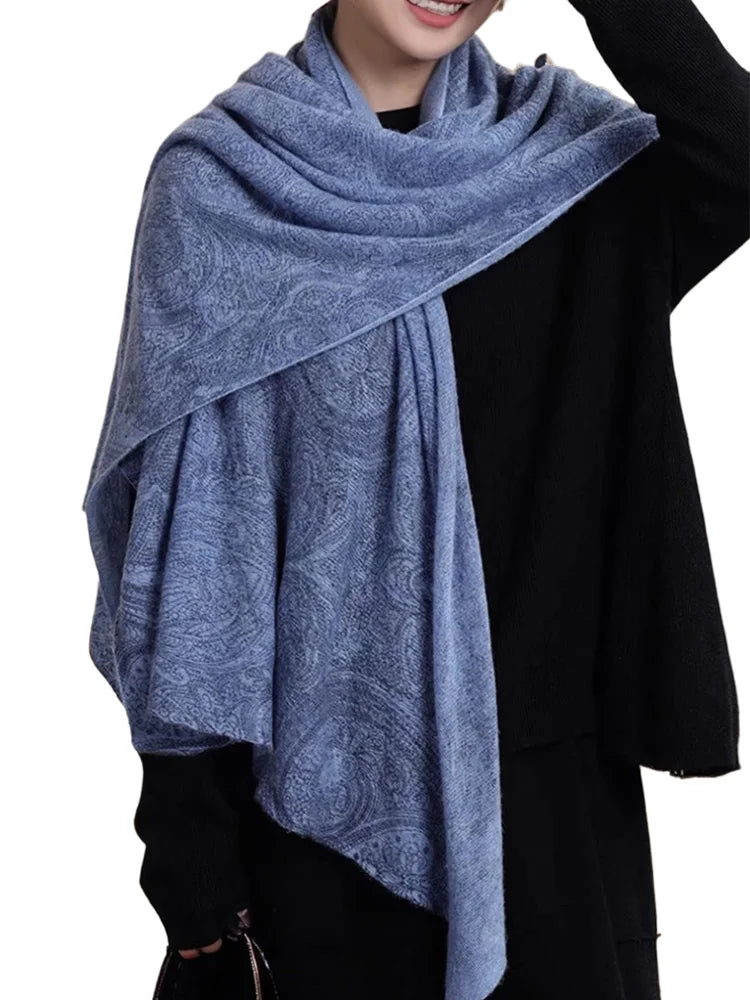 Person wearing a blue patterned scarf on a white background