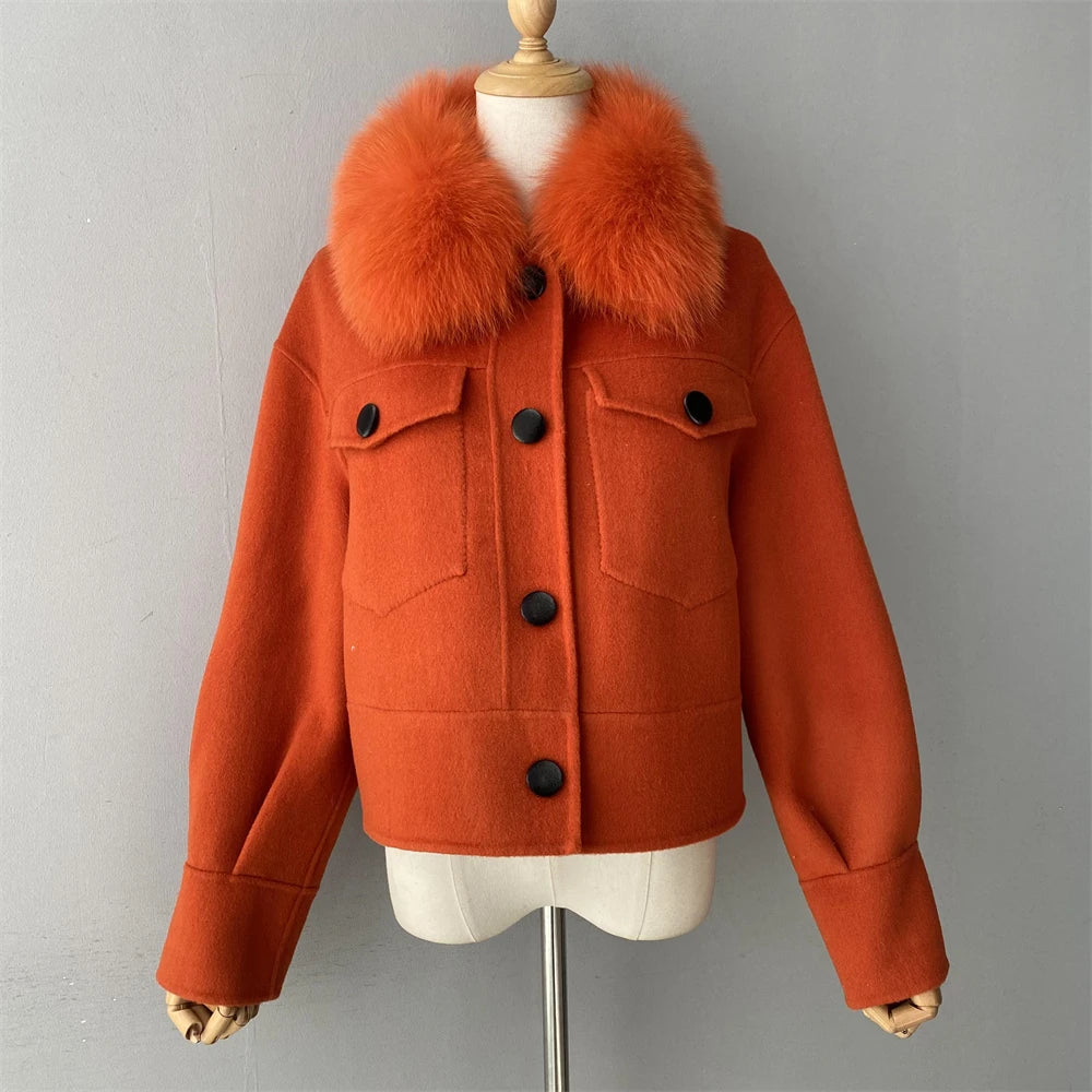 Orange jacket with fur collar on a mannequin against a gray background