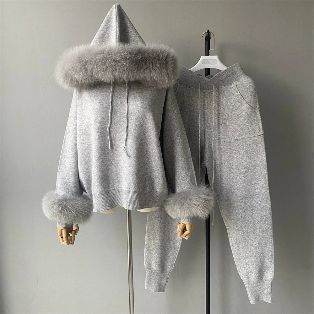 Gray hoodie with fur trim on a mannequin against a plain background