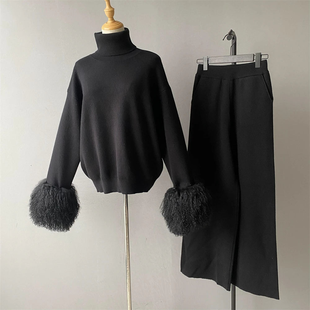 Black sweater with fluffy cuffs and a black skirt on a mannequin against a plain background