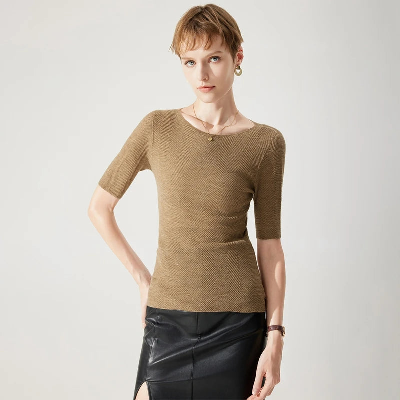 Woman wearing a brown textured top and black skirt on a white background