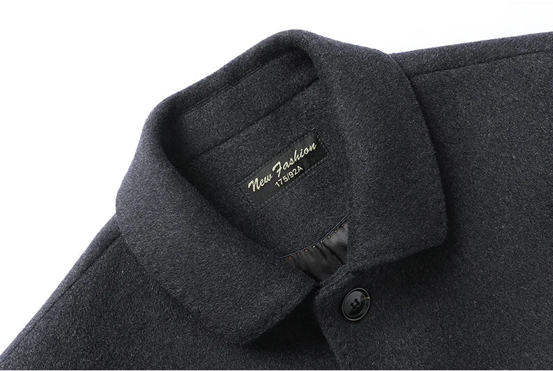 Close-up of a dark gray coat collar with a brand label.