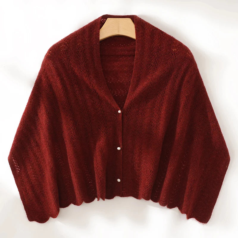Red cardigan on a wooden hanger against a white background