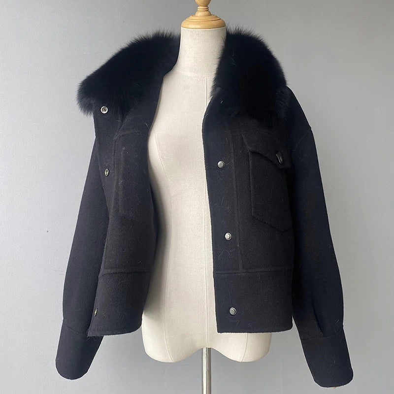 Black jacket with fur collar on a mannequin against a gray background