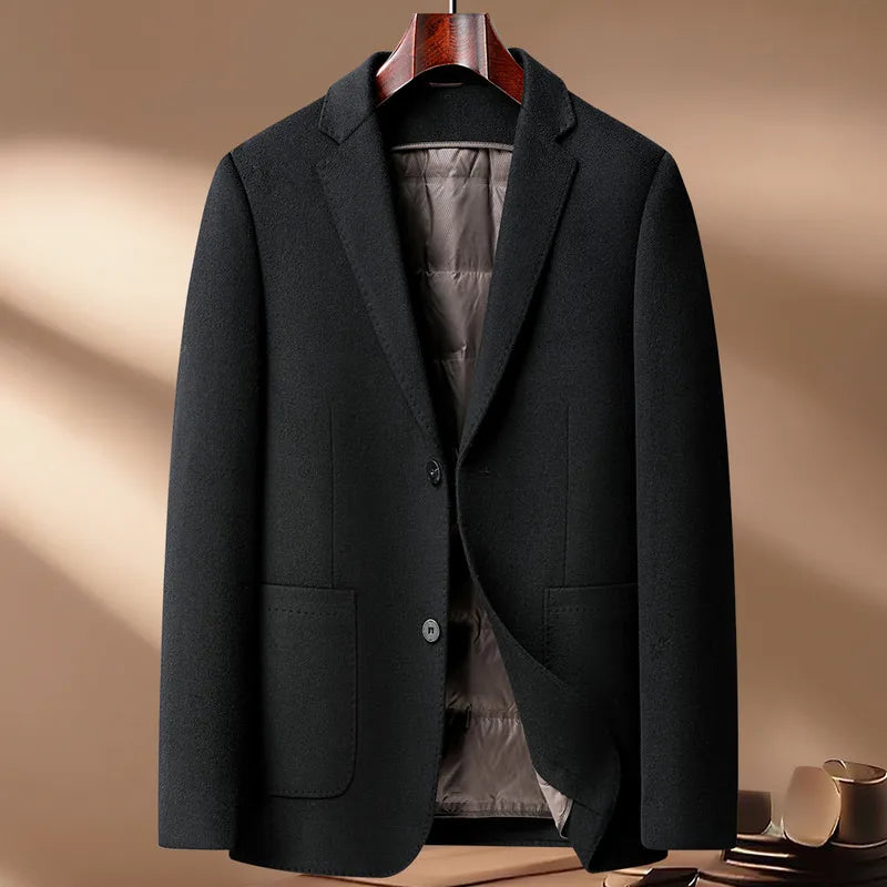 Dark gray blazer on a hanger against a beige background