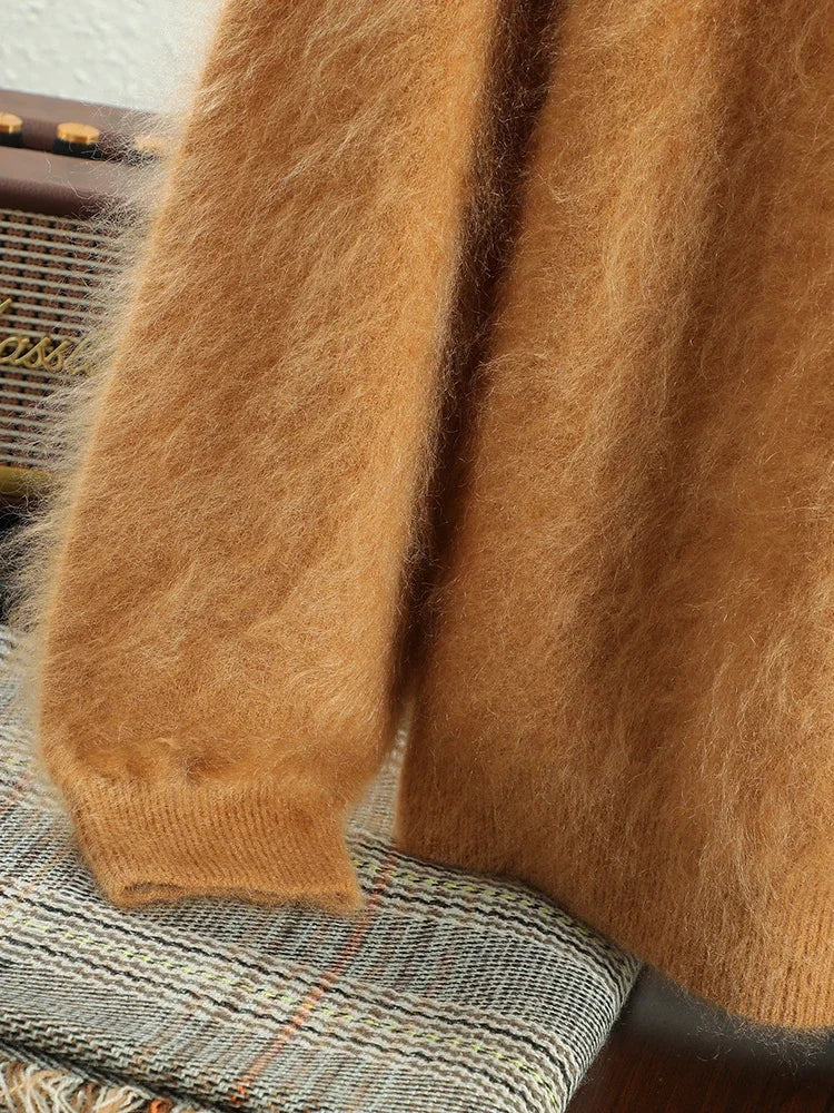 Close-up of a brown fuzzy sweater on a textured surface
