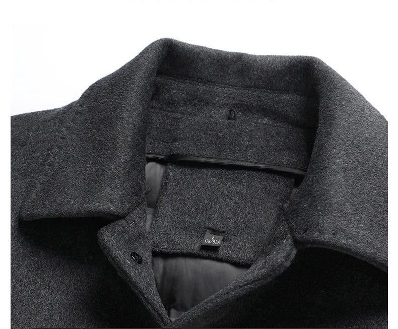 Close-up of a gray coat with a collar and brand logo on a white background