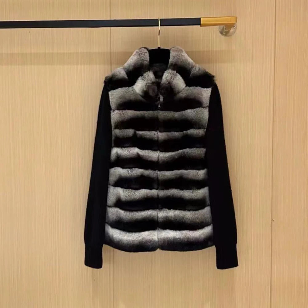 Black puffer jacket with fur hood on a wooden background