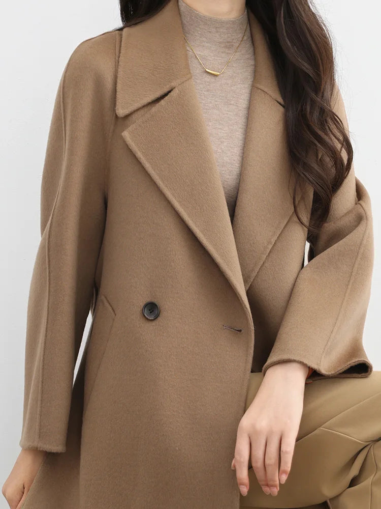 Person wearing a brown coat on a white background