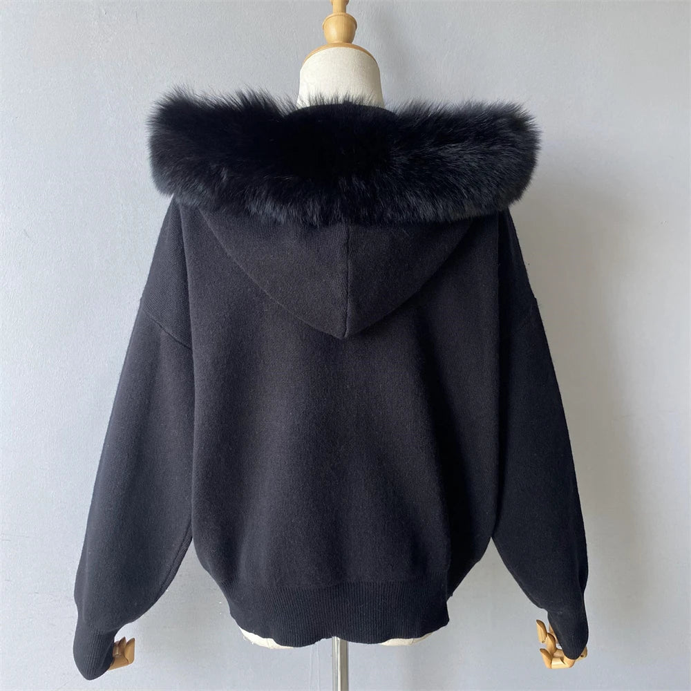 Black hoodie with fur hood on a mannequin against a plain background