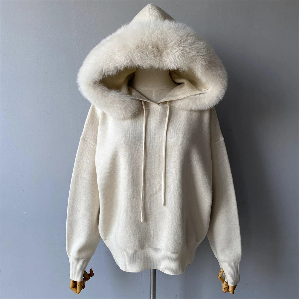 White hoodie with fur-lined hood on a mannequin against a gray background