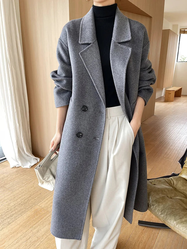 Person wearing a gray coat in an indoor setting