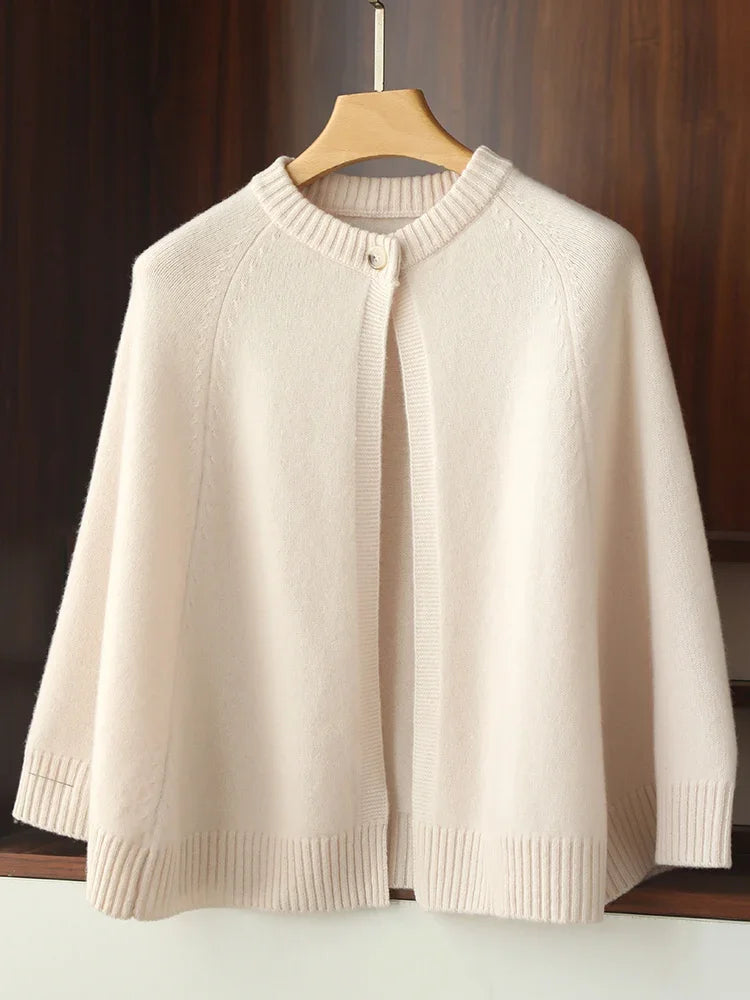 Beige sweater on a wooden hanger against a wooden background