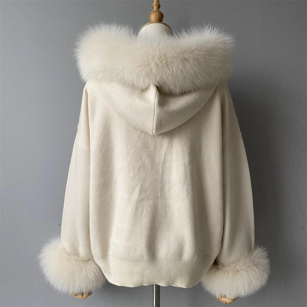 Beige hooded coat with fur trim on a mannequin against a gray background