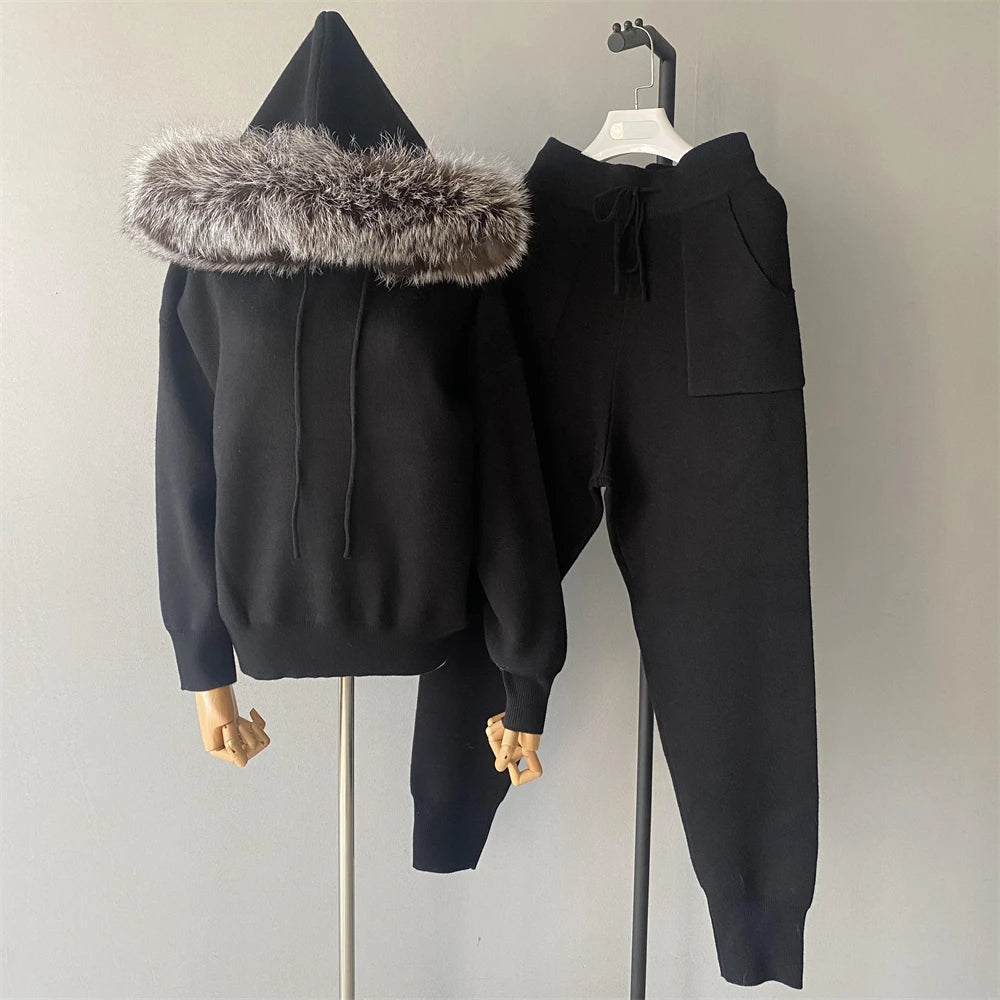 Black hoodie with fur-lined hood and matching pants on a mannequin against a plain background