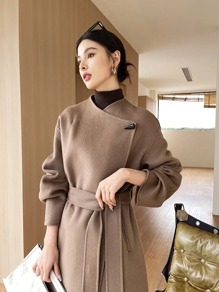 Woman wearing a brown coat in an indoor setting
