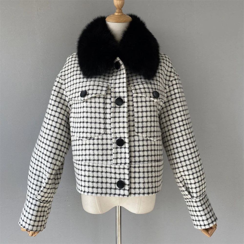 Black and white checkered jacket with a black fur collar on a mannequin against a gray background