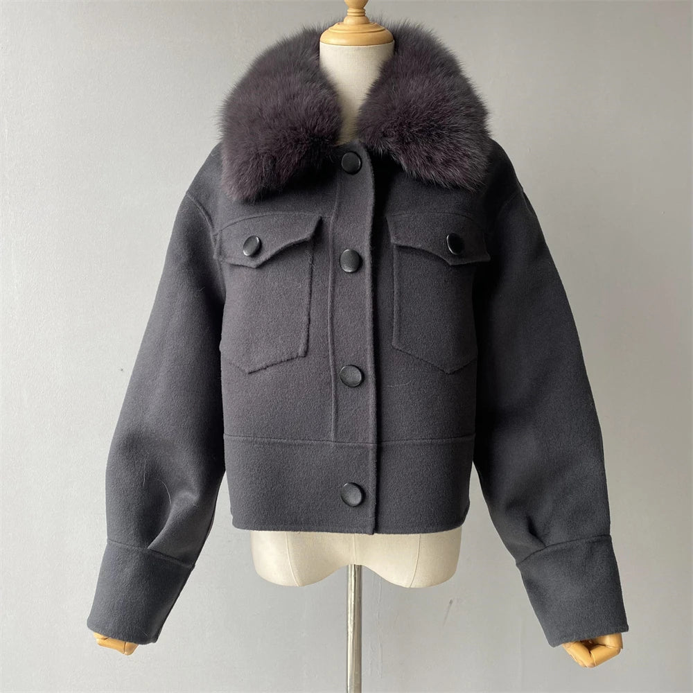 Gray jacket with fur collar on a mannequin against a plain background