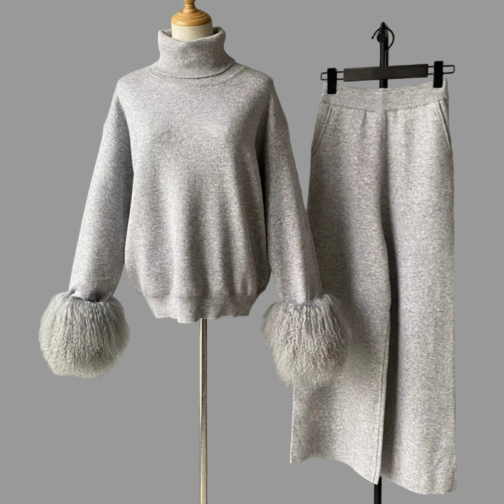 Gray sweater with fluffy cuffs and a matching skirt on a mannequin and hanger against a gray background.